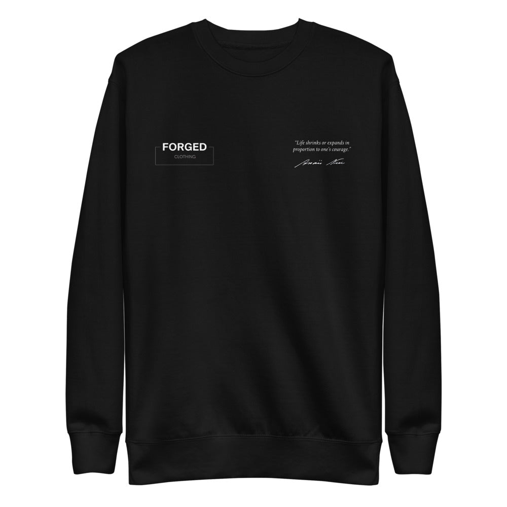 Forged Definition Crewneck negra, vista delantera con el logo Forged Clothing y la frase de Anaïs Nin